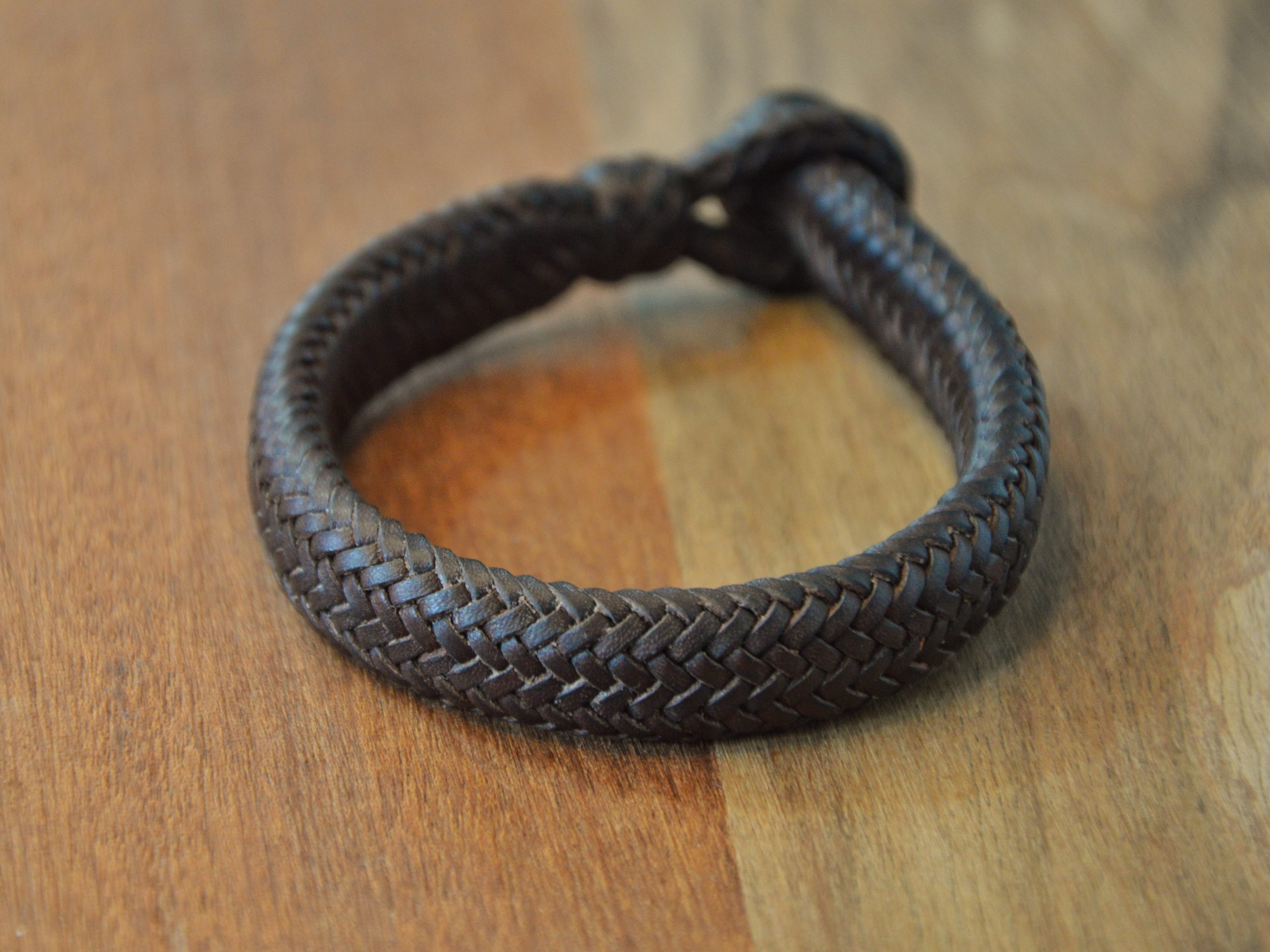 "Pulsera 16T Rectangular disponible por €170.00. Elaborada con piel de curtido vegetal de color marrón tabaco, esta pulsera presenta una trenza rectangular con alma maciza de cuero en su interior. "Una pulsera de calidad que aporta un toque distintivo a tu estilo."